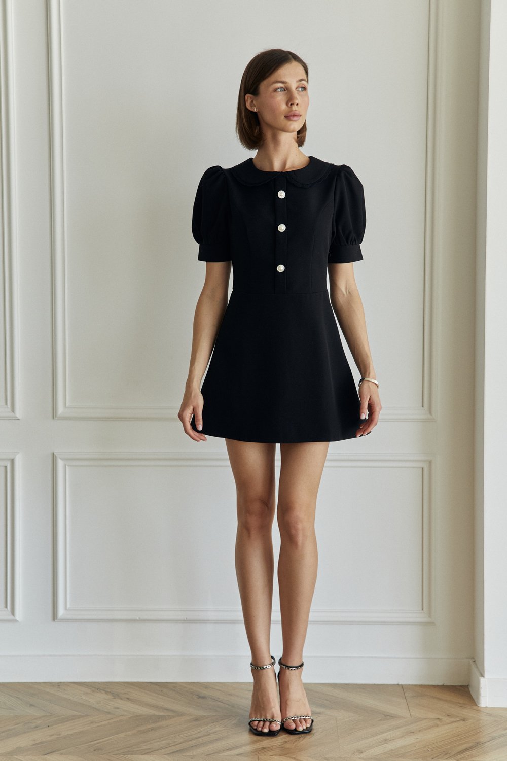 Black fitted mini dress with a-line skirt