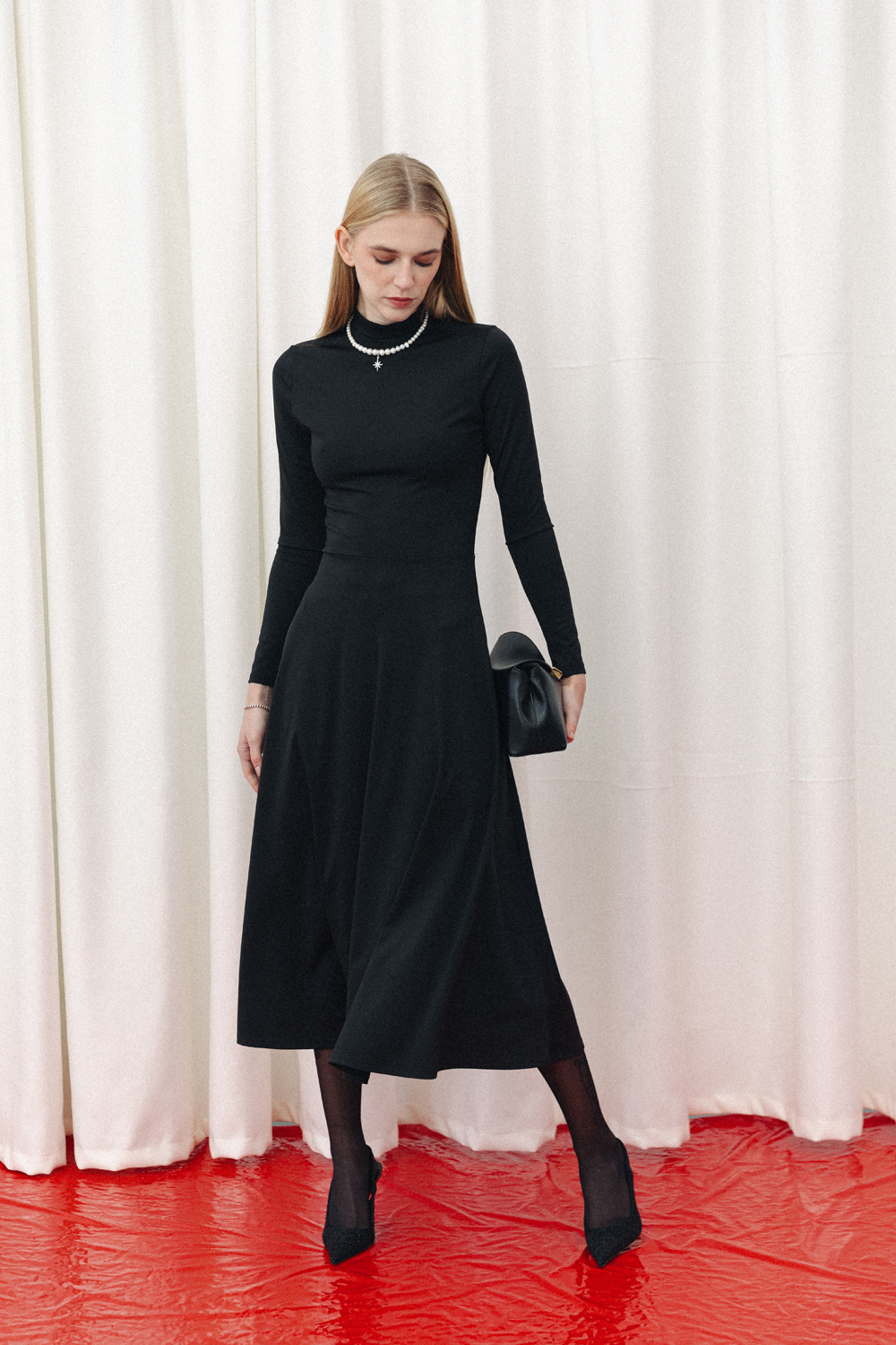 Black fitted midi dress with sophisticated flared skirt