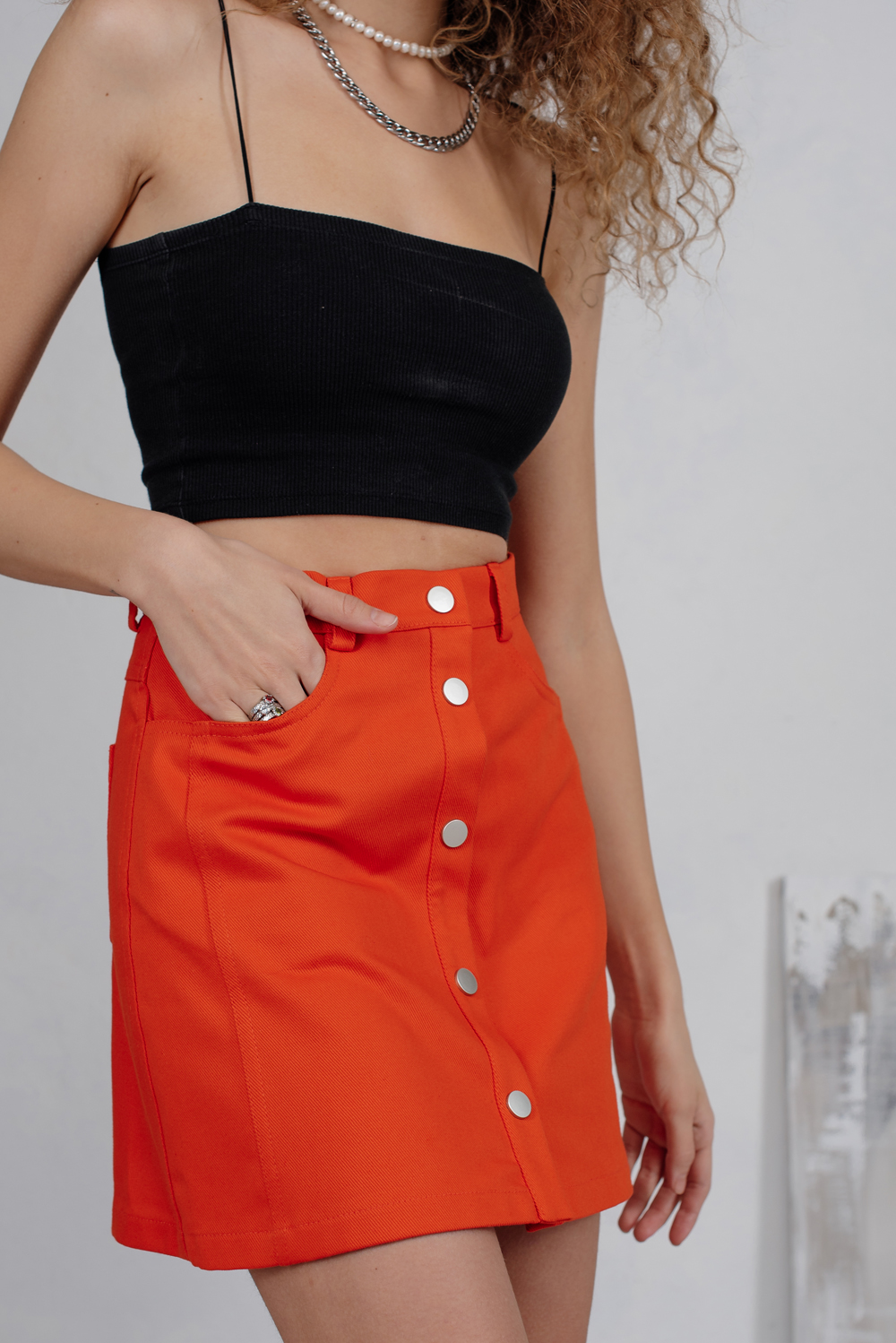 Orange denim mini skirt with studs