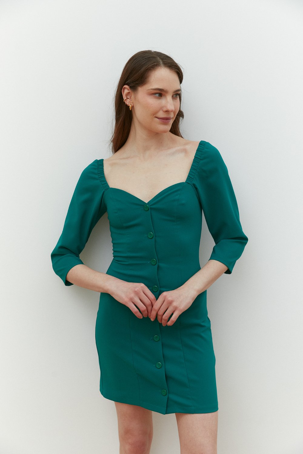 Green fitted mini dress with deep neckline