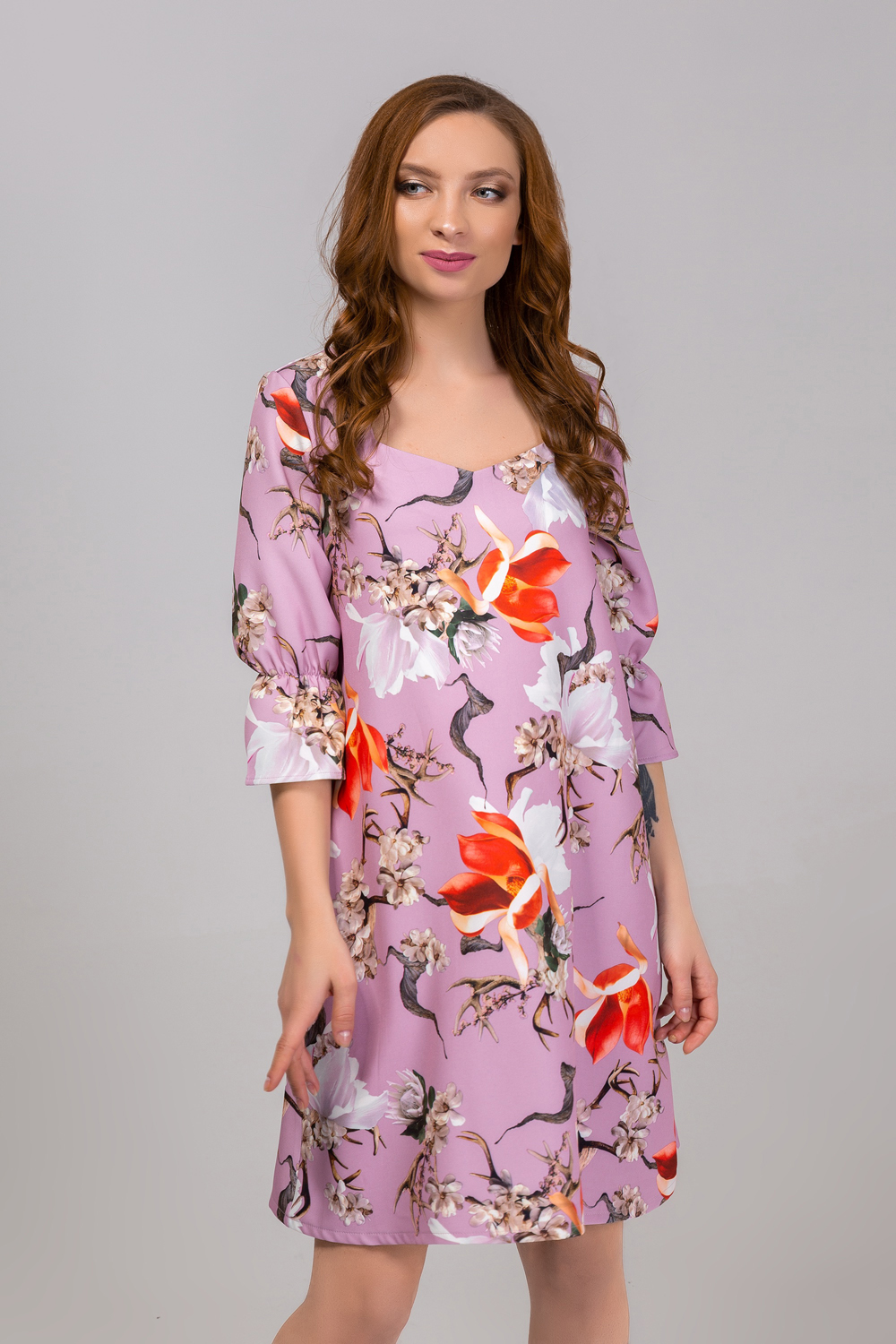 Dress in flowers with a ruffle on the sleeve