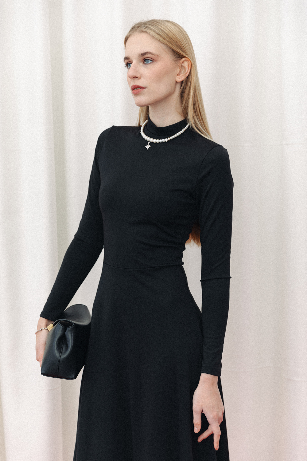 Black fitted midi dress with sophisticated flared skirt