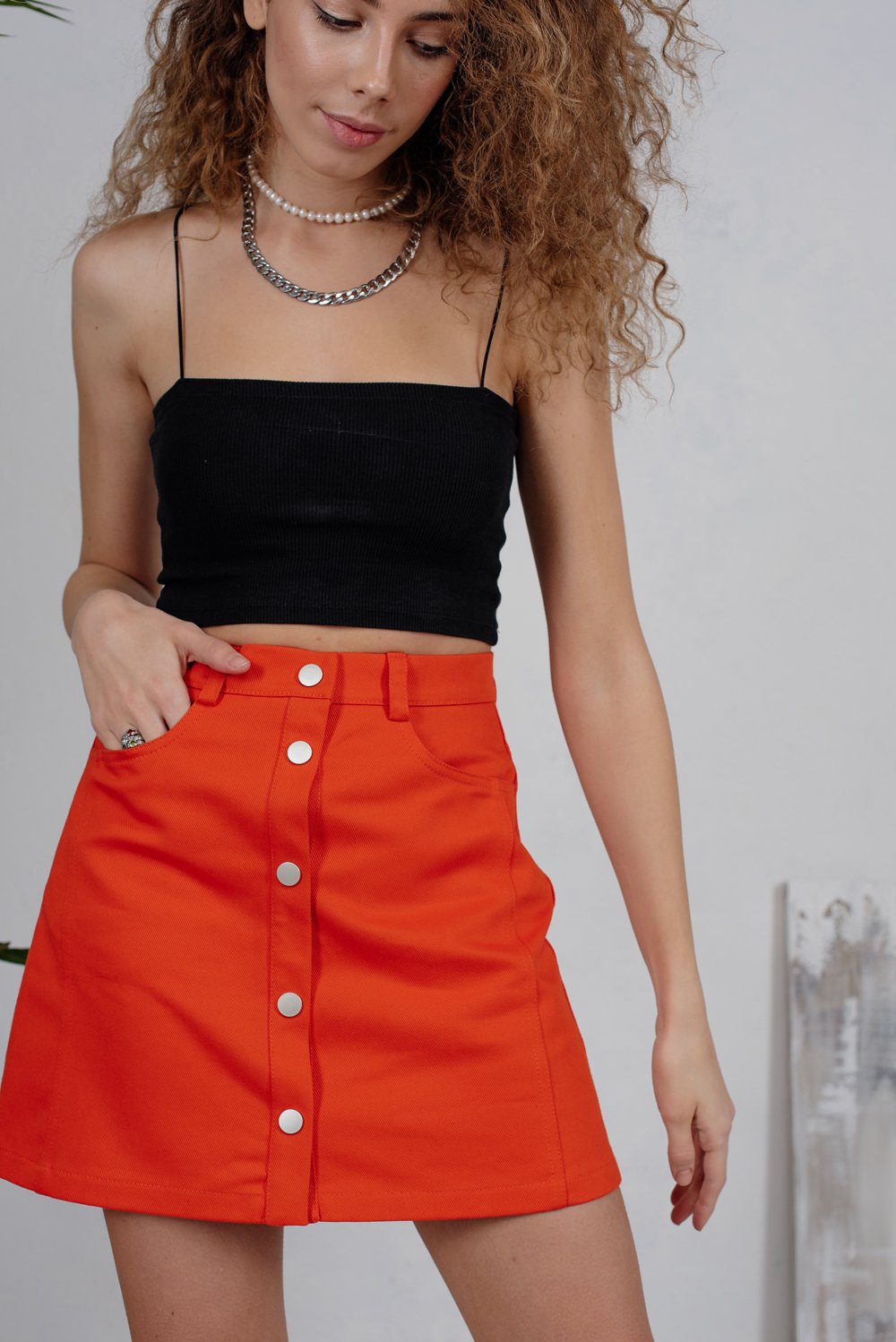 Orange denim mini skirt with studs