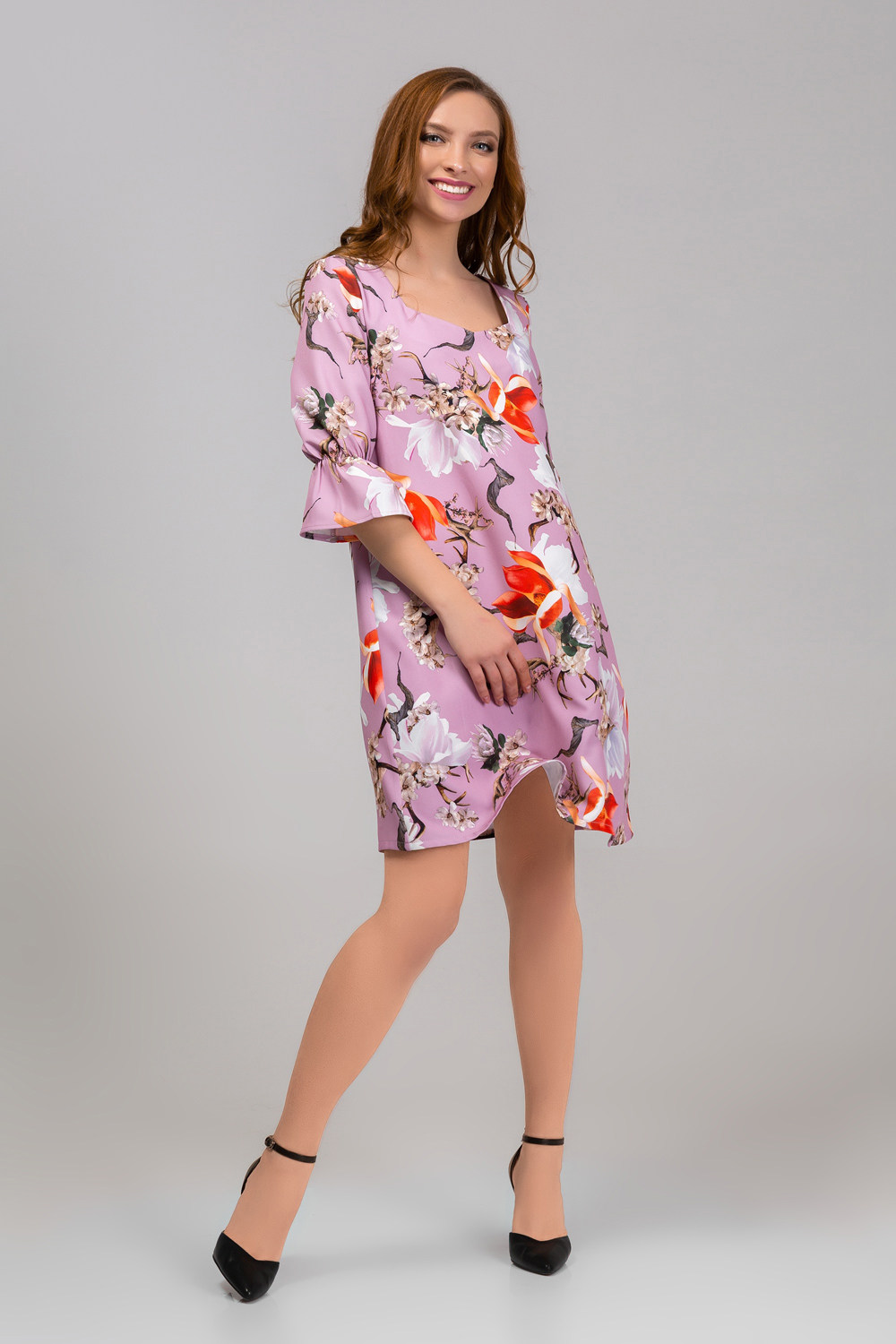 Dress in flowers with a ruffle on the sleeve