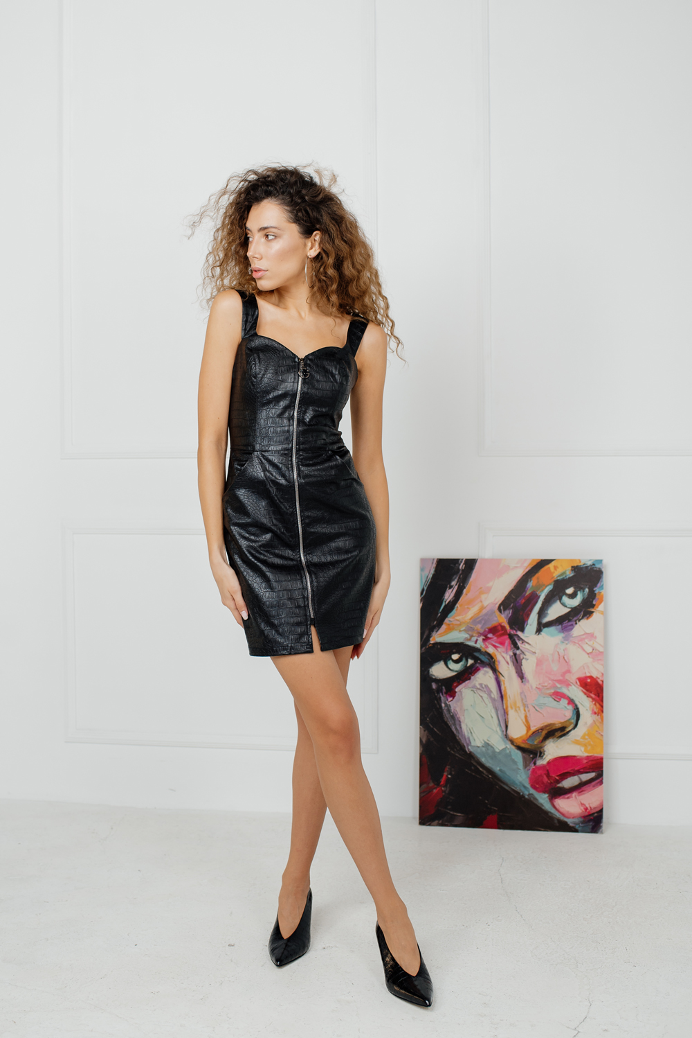 Black sleeveless eco leather mini dress with a zipper 