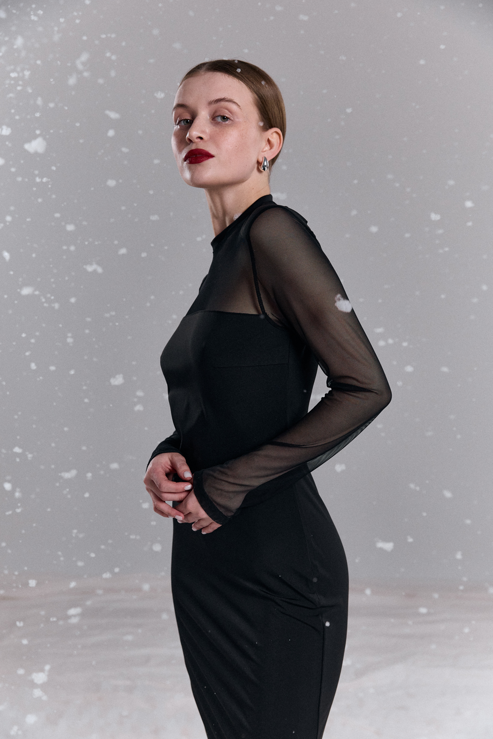 Black fitted dress with elegant mesh inserts