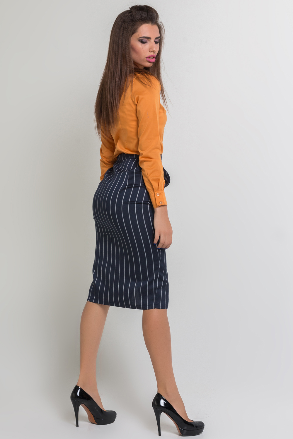 Midi length striped skirt with pockets and front cutout.