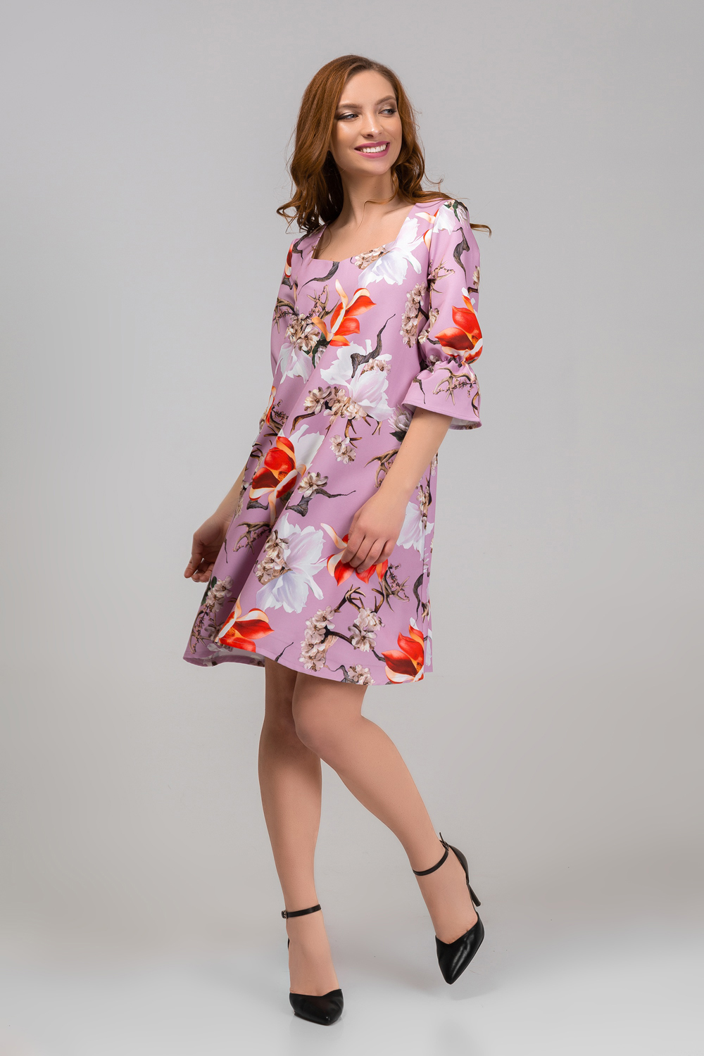 Dress in flowers with a ruffle on the sleeve