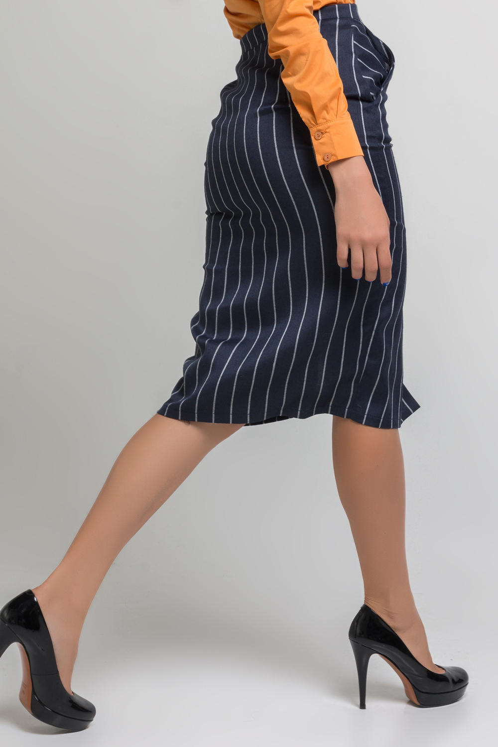 Midi length striped skirt with pockets and front cutout.