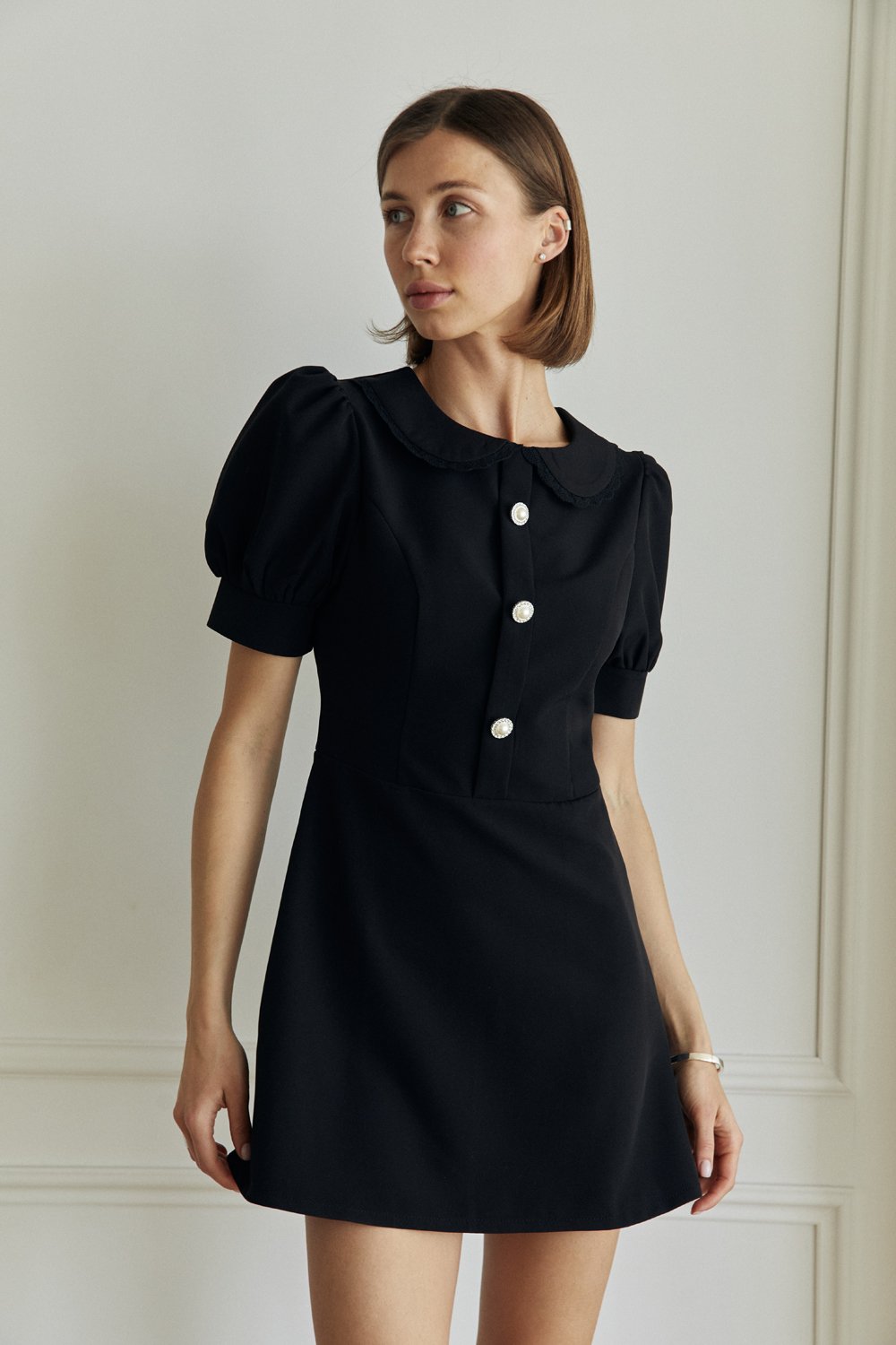 Black fitted mini dress with a-line skirt