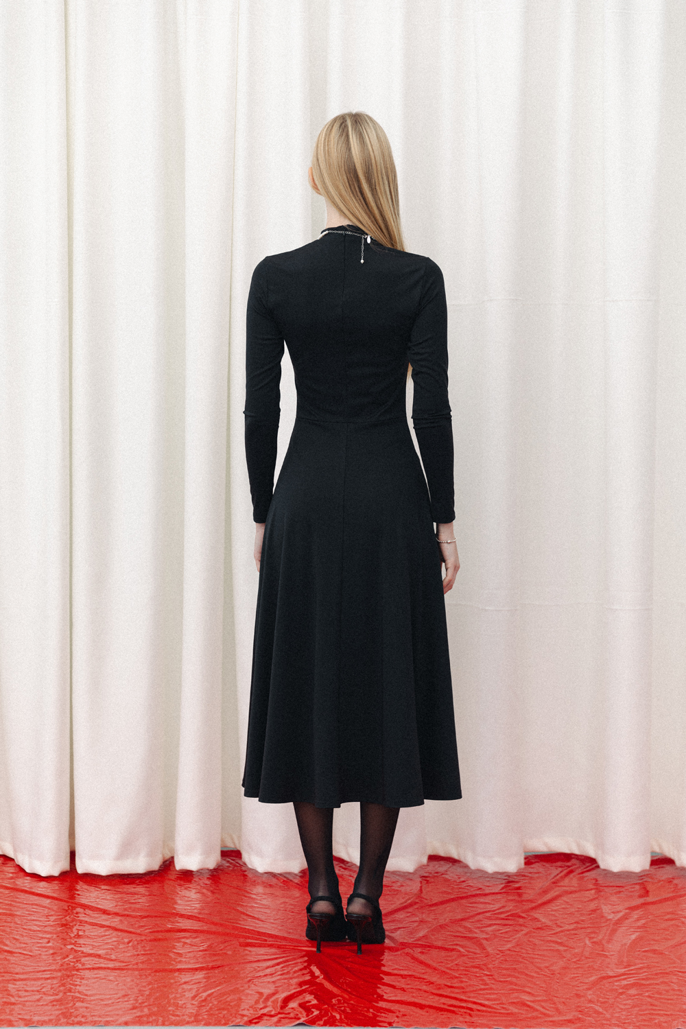 Black fitted midi dress with sophisticated flared skirt