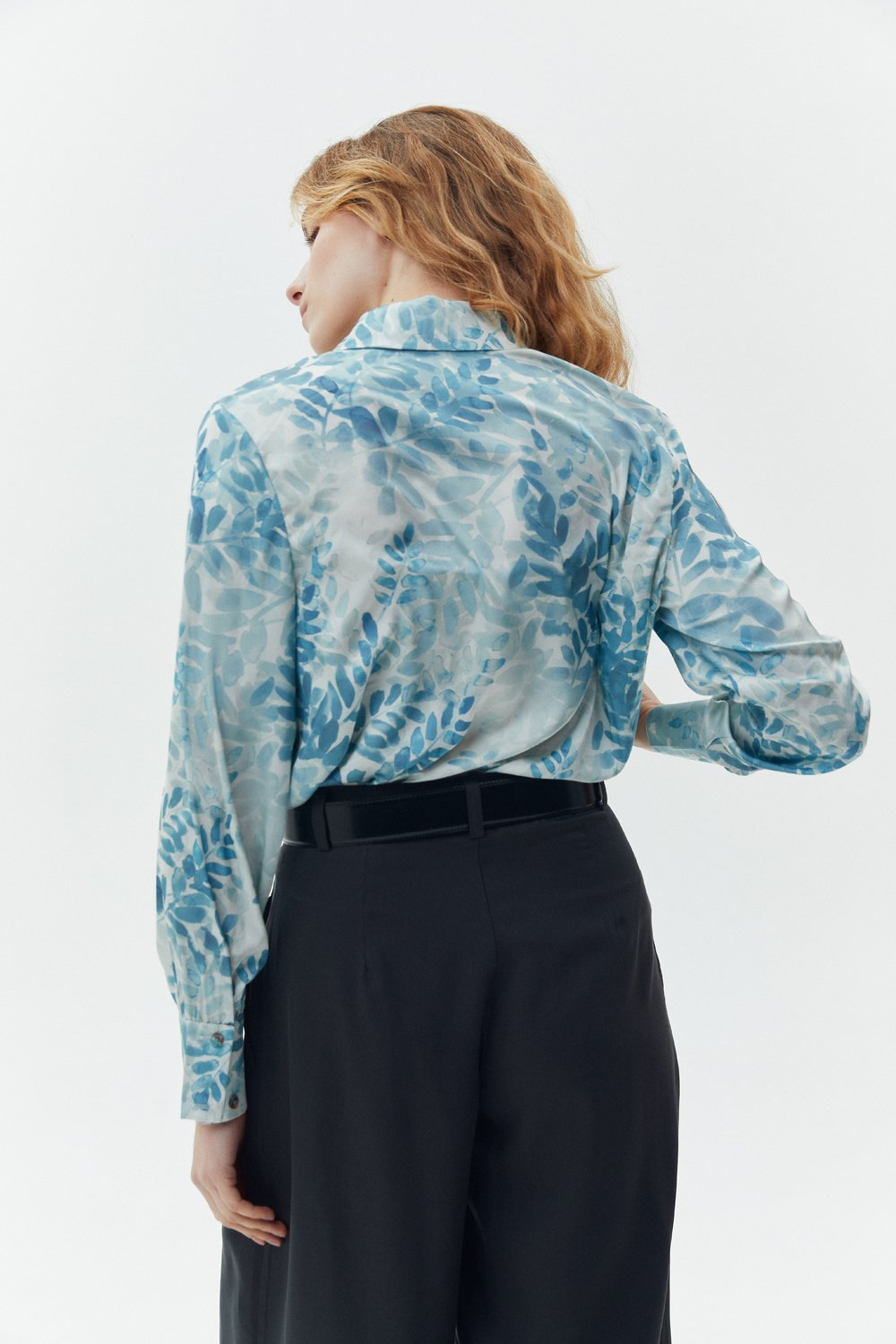 Elegant loose-fitting turquoise blouse