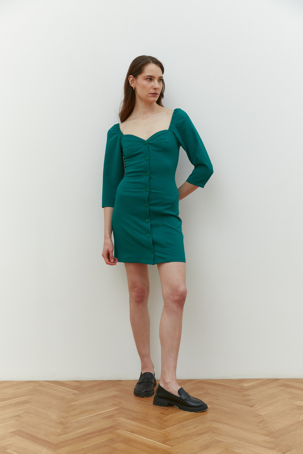 Green fitted mini dress with deep neckline