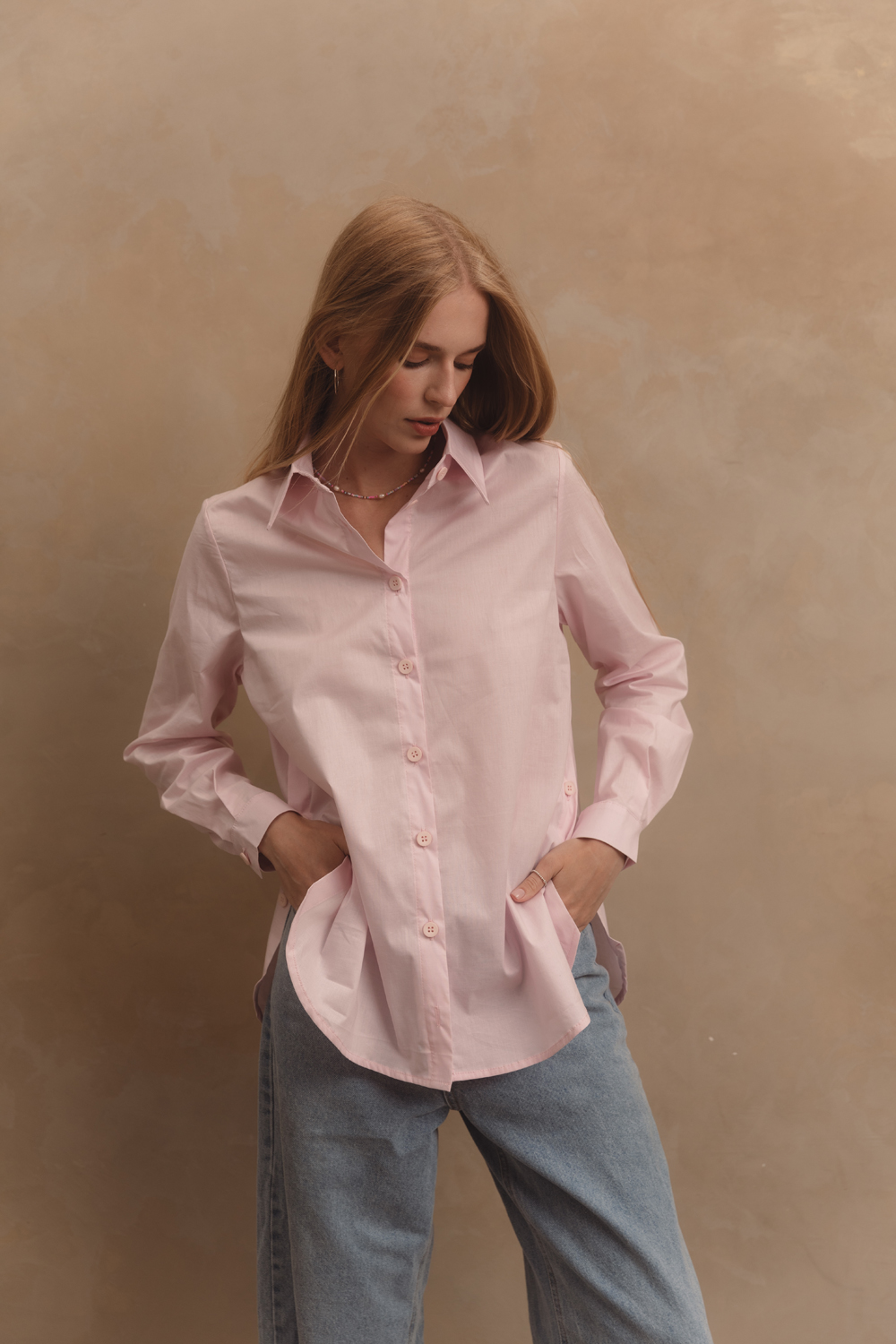 Pink cotton shirt with functional buttons on the sides