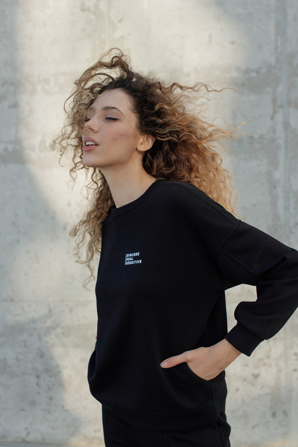 Black sweatshirt with lettering and pockets