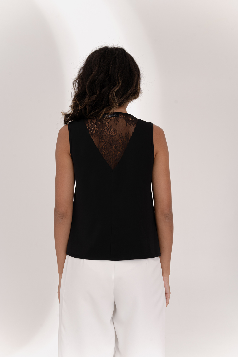 Black sleeveless top with lace insert on the back