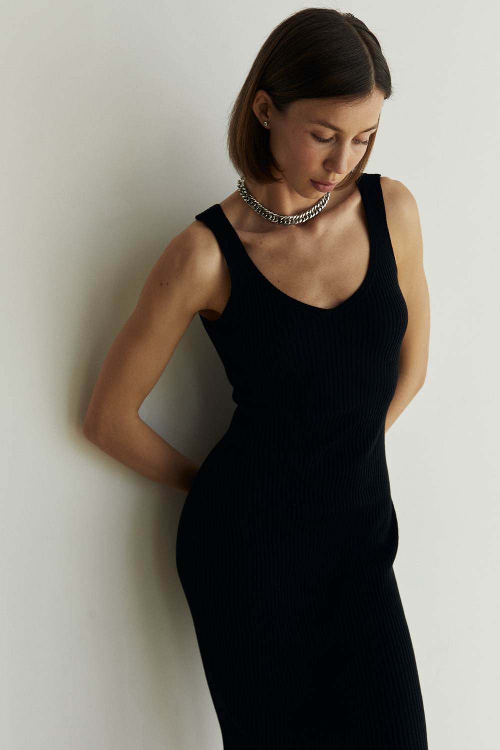 Black knit dress with V-neck and spaghetti straps