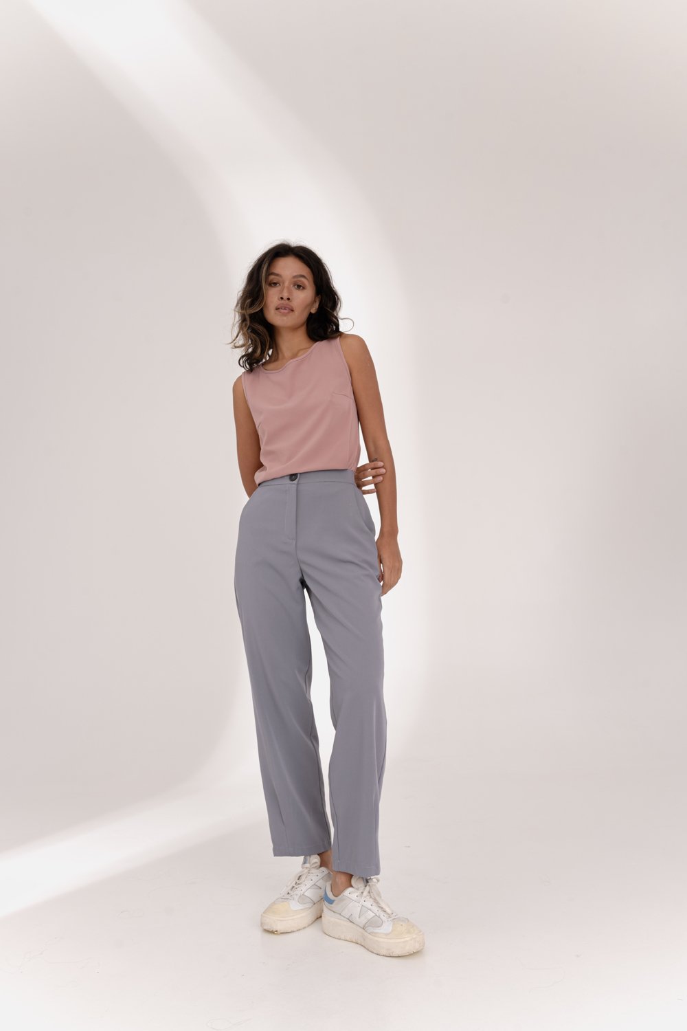 Gray trousers with an elasticated waistband and pleats at the hem