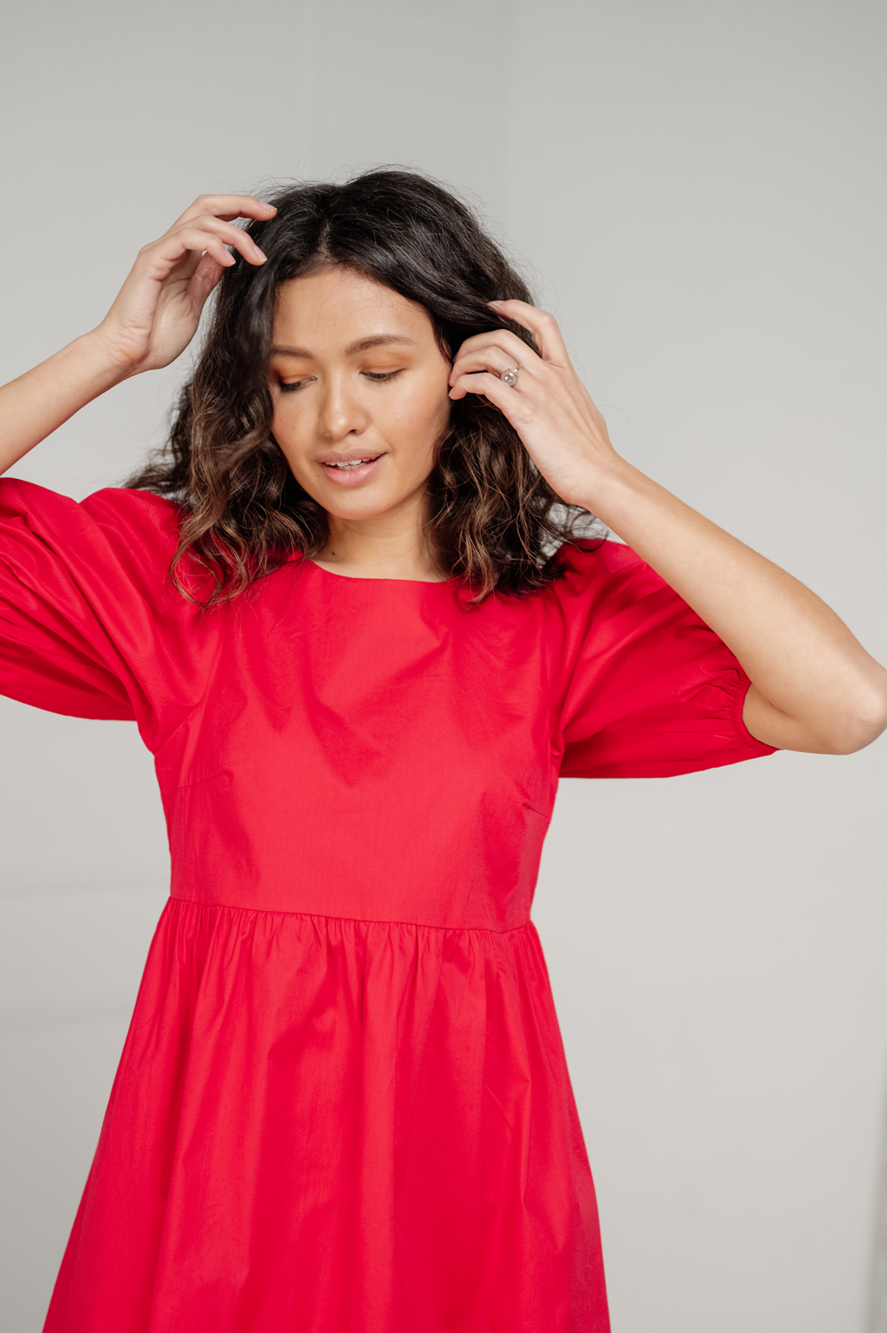 Red cotton mini dress with loose skirt.