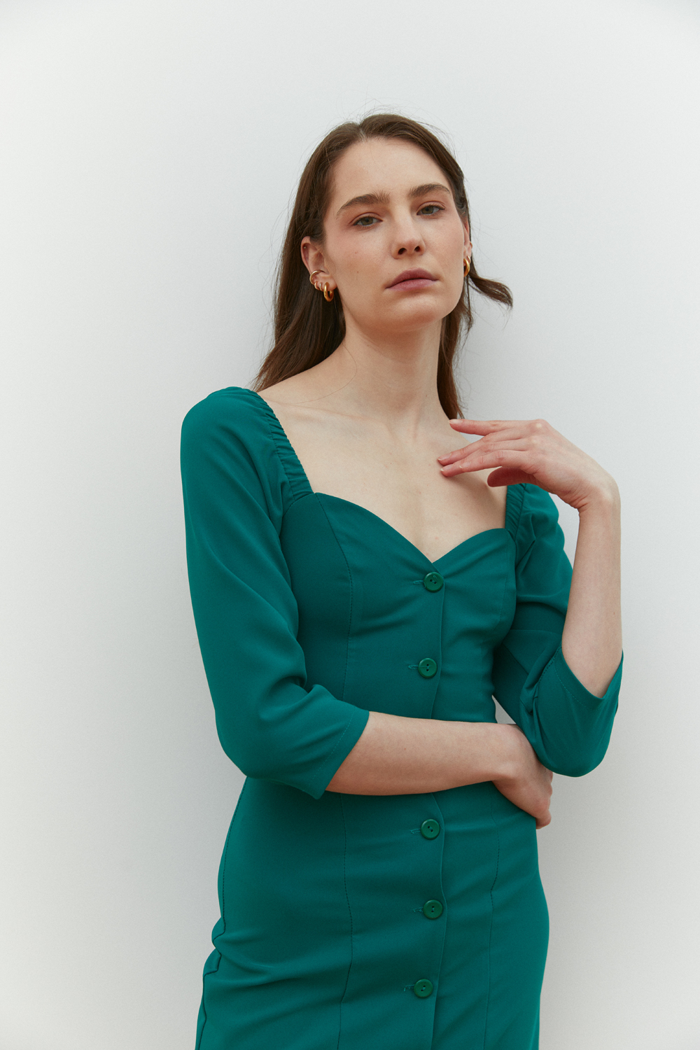Green fitted mini dress with deep neckline
