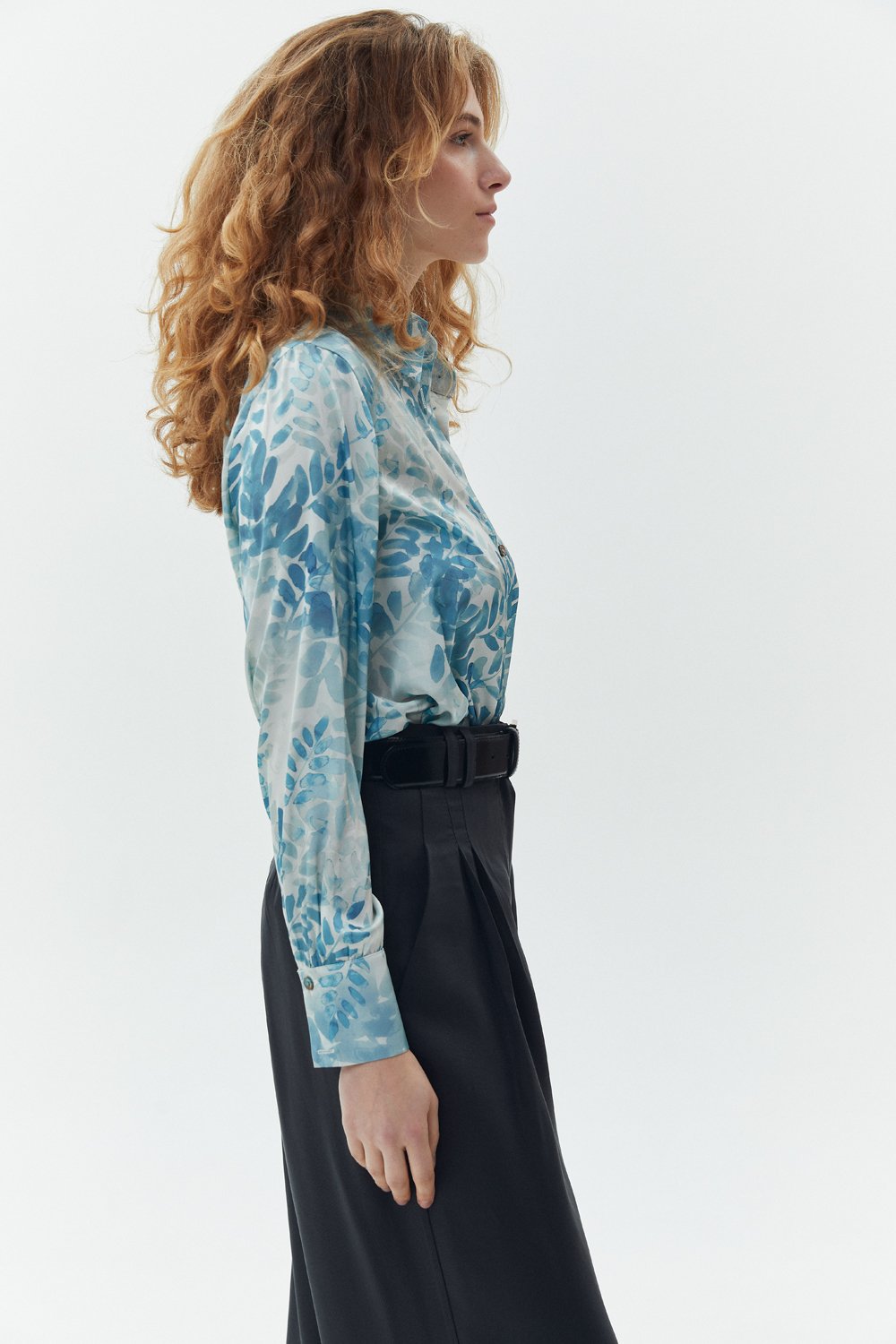 Elegant loose-fitting turquoise blouse
