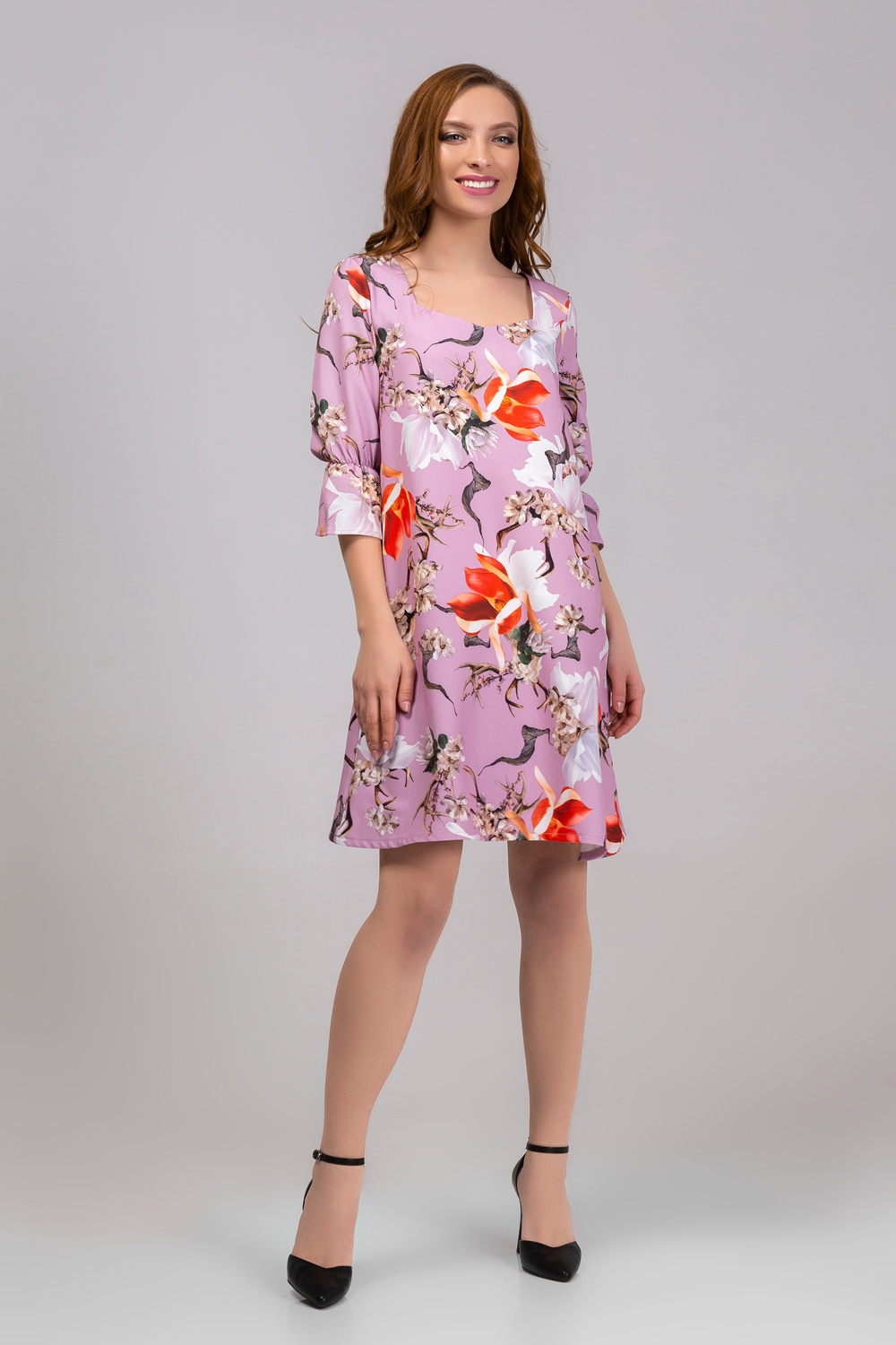 Dress in flowers with a ruffle on the sleeve