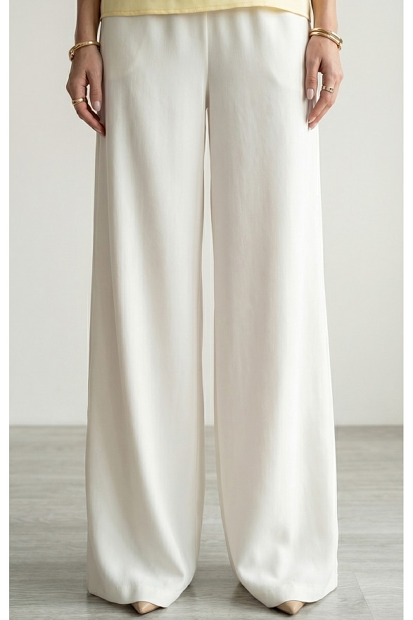 Білі вільні жіночі штани на гумці з кишенями