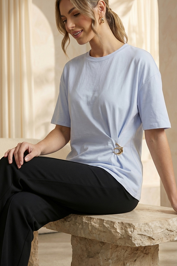 Light blue asymmetrical loose T-shirt with a slit and a brooch