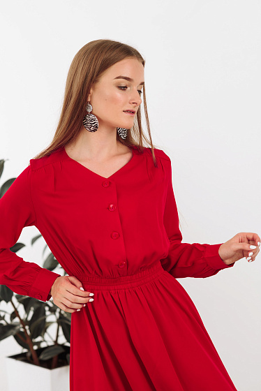 Midi dress made of delicate cotton fabric. Featuring a V-shaped neckline, front buttons fastening, assembly on the shoulder, long sleeves with cuffs and buttons, comfortable elastic at the waist, loose skirt.