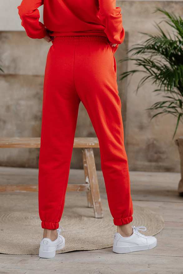 Помаранчеві спортивні штани з написом