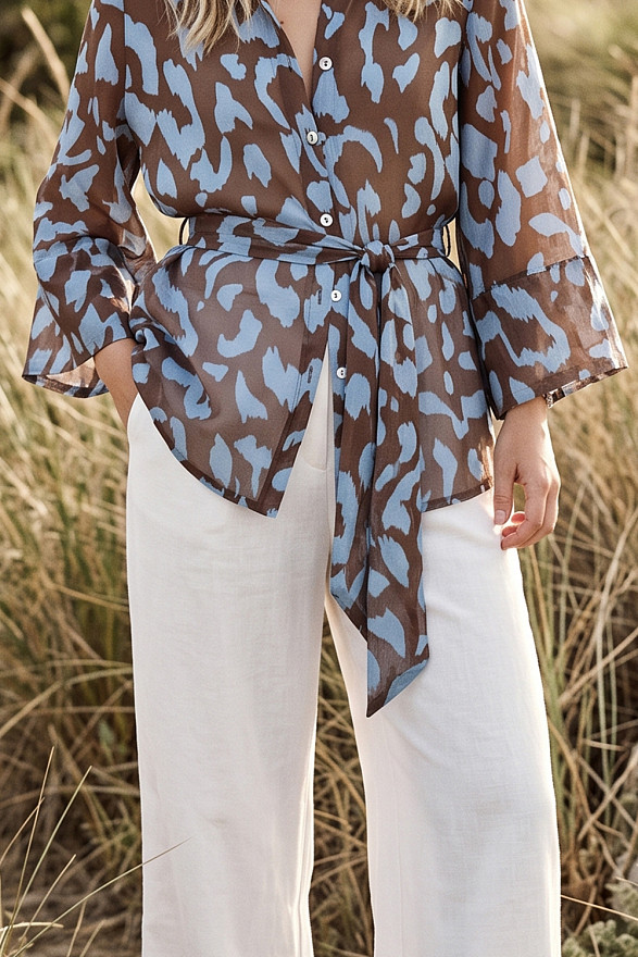 Light blue loose-fitting shirt with a belt