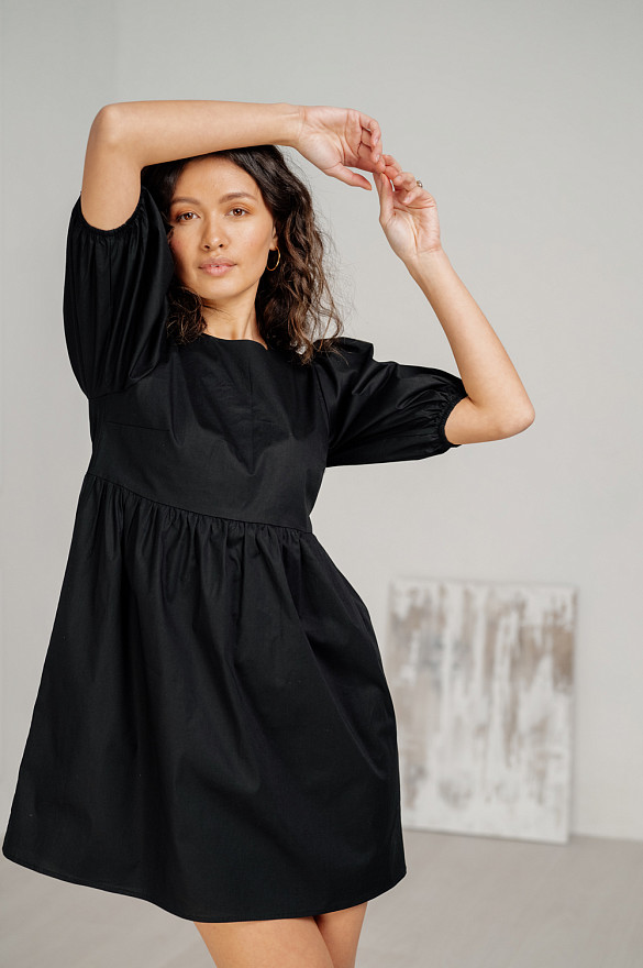 Black cotton mini dress with loose skirt.