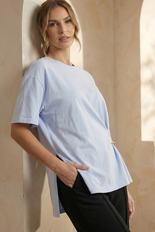 Light blue asymmetrical loose T-shirt with a slit and a brooch