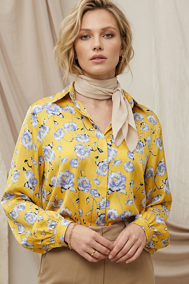 Loose-fit blouse with puff sleeves and a stand-up collar. This button-down piece offers a soft silhouette that flatters any figure while ensuring freedom of movement. A perfect balance of comfort and sophistication, easily adaptable for office dress codes or stylish casual looks.