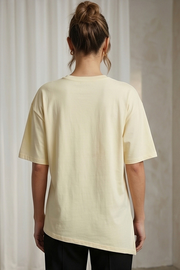 Yellow asymmetrical loose T-shirt with a slit and a brooch