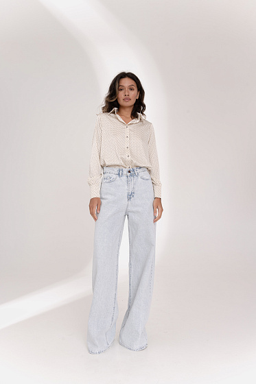 Джинсы имеют расширенные штанины к низу, два полукруглых кармана спереди и два накладных кармана сзади. Застежка - молния и пуговица. 