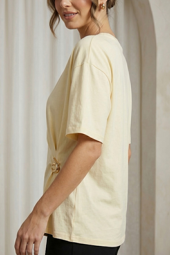 Yellow asymmetrical loose T-shirt with a slit and a brooch