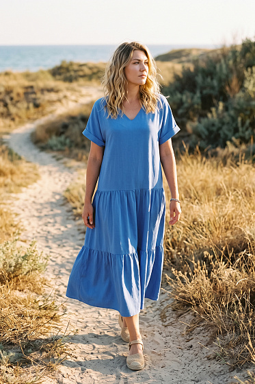 Midi dress with a V-neck and accent ruffles at the hem. Dropped shoulders and cuffed sleeves create a modern, relaxed silhouette. The model can be easily combined with heels or minimalist sandals, suitable for everyday and evening looks.