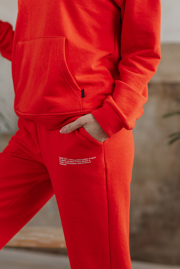 Помаранчеві спортивні штани з написом