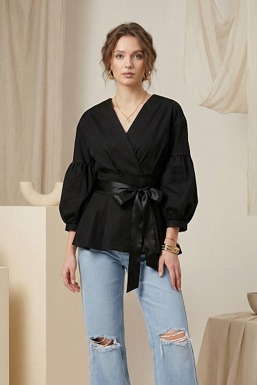 Stylish wrap shirt featuring a button-up back closure. Designed with dropped shoulders, gathered cuffs, and a pleated peplum hem. This unique cut emphasizes individuality while creating a modern, feminine silhouette. A perfect choice for striking casual and evening looks, combining elegance with contemporary design.