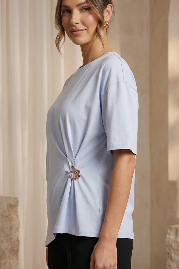 Light blue asymmetrical loose T-shirt with a slit and a brooch