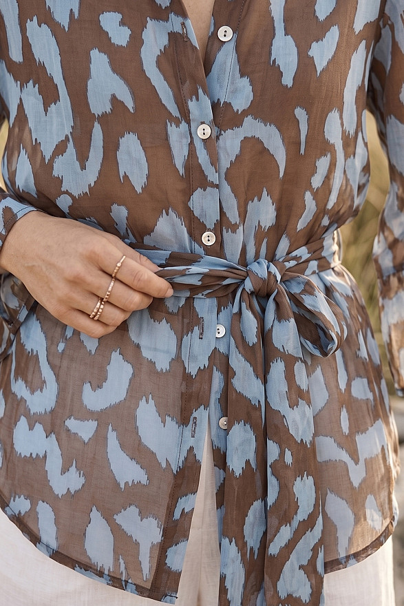 Light blue loose-fitting shirt with a belt