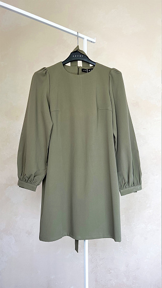 Stylish dress with puffy long sleeves, round neckline, hidden zipper at the back. The waist is accentuated with a belt.