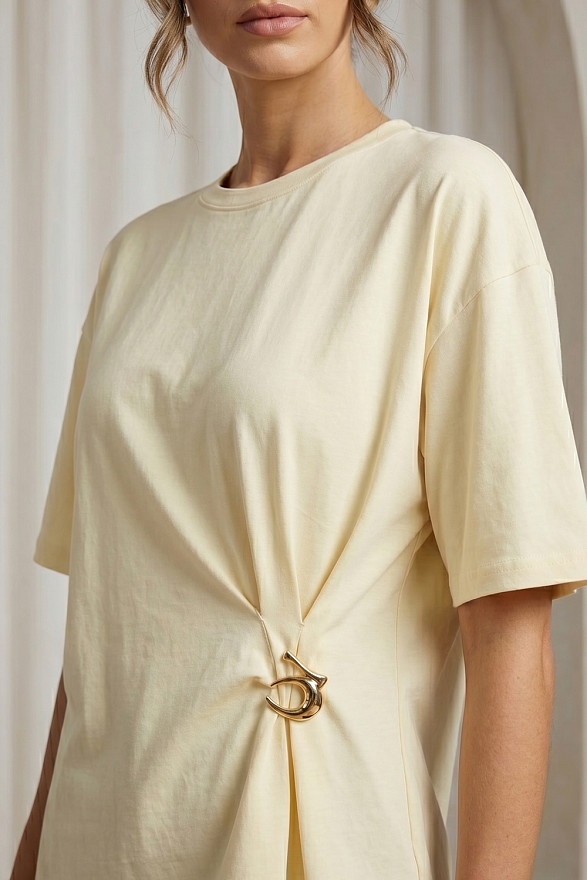 Yellow asymmetrical loose T-shirt with a slit and a brooch