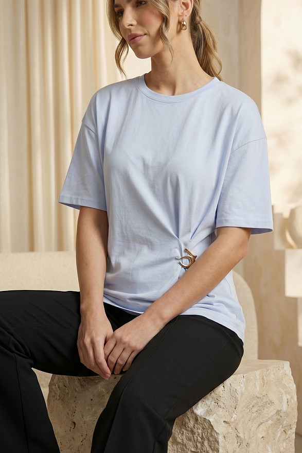 Light blue asymmetrical loose T-shirt with a slit and a brooch