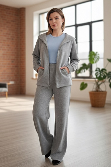 This stylish walking suit made of soft knitted angora is the perfect choice for cooler days. The pants feature an elastic waistband and side pockets for a comfortable and snug fit. The loose, zip-up sweatshirt with dropped sleeves and a hood adds a relaxed, modern touch. The suit is perfect for walks, lounging, and everyday wear.