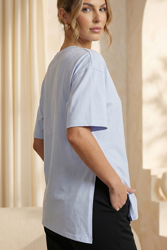 Light blue asymmetrical loose T-shirt with a slit and a brooch
