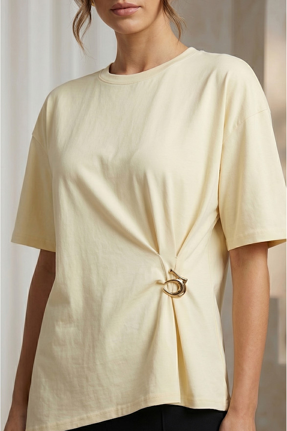 Yellow asymmetrical loose T-shirt with a slit and a brooch