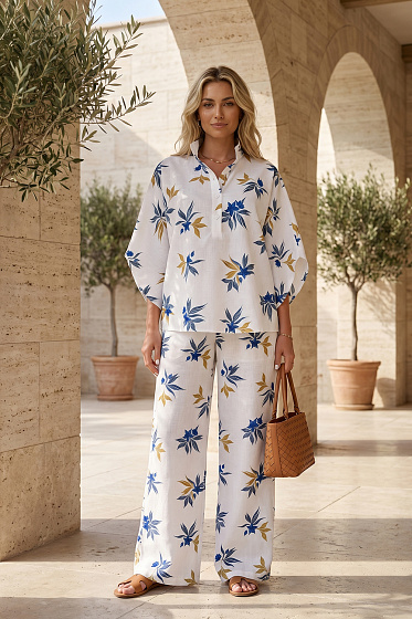 A contemporary set featuring a relaxed stand-collar shirt and wide-leg trousers with an elasticated waistband. Clean lines, refined tailoring and a minimalist aesthetic create a versatile wardrobe essential for modern city dressing. Easy to style with both timeless basics and statement pieces.