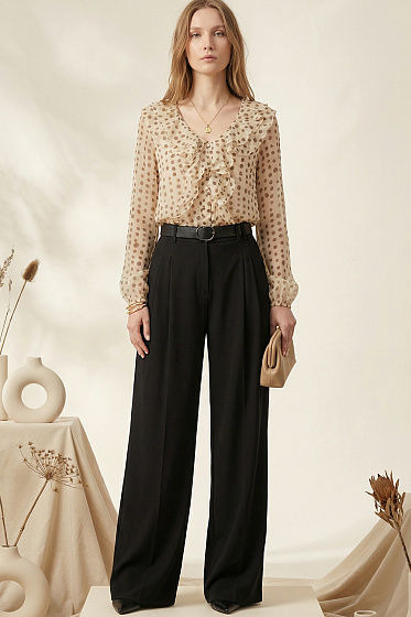 Elegant double-ruffle blouse with a flattering V-neckline. Features long elasticated sleeves for a sophisticated silhouette. Perfectly pairs with skirts, trousers, or jeans for both professional and festive occasions. A versatile wardrobe essential that blends romantic ruffles with timeless style.